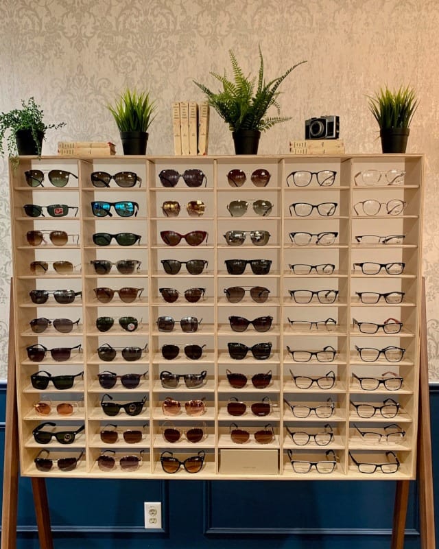 The frame display board in the optical lounge, sunglasses and spectacles on plywood shelves